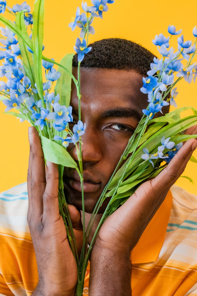 Man Holding Blue Flowers